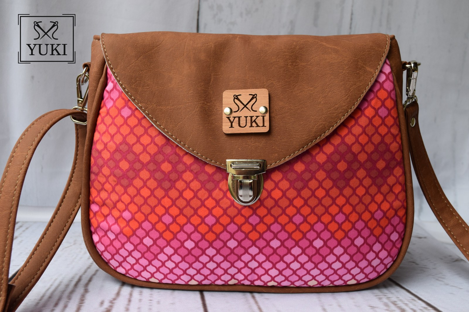 Yuki Chloe crossbody bag in vibrant pink patterned fabric and warm brown faux leather